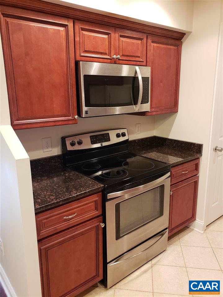 104 Turtle Creek Road, Unit 4 Charlottesville, VA 22901 - Photo 3 of 18 a kitchen with granite countertop a stove and a microwave