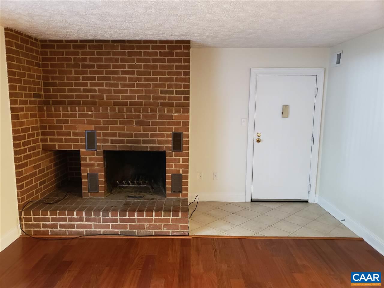 104 Turtle Creek Road, Unit 4 Charlottesville, VA 22901 - Photo 7 of 18 a view of a livingroom with wooden floor and a fireplace