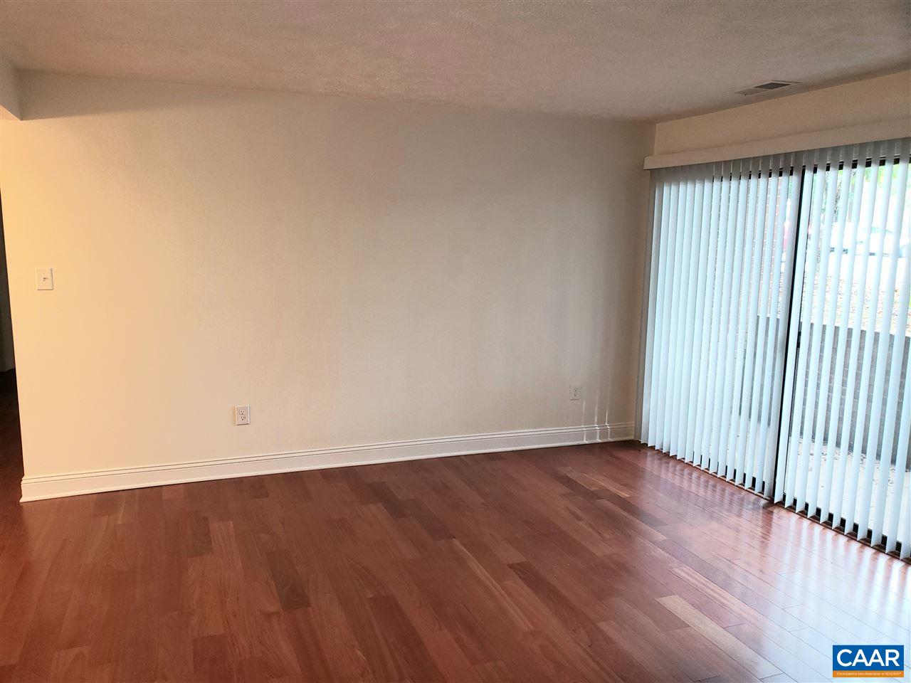 104 Turtle Creek Road, Unit 4 Charlottesville, VA 22901 - Photo 8 of 18 a view of an empty room with wooden floor and a window