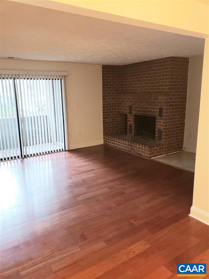 104 Turtle Creek Road, Unit 4 Charlottesville, VA 22901 - Photo 9 of 18 a view of a livingroom with wooden floor and a fireplace