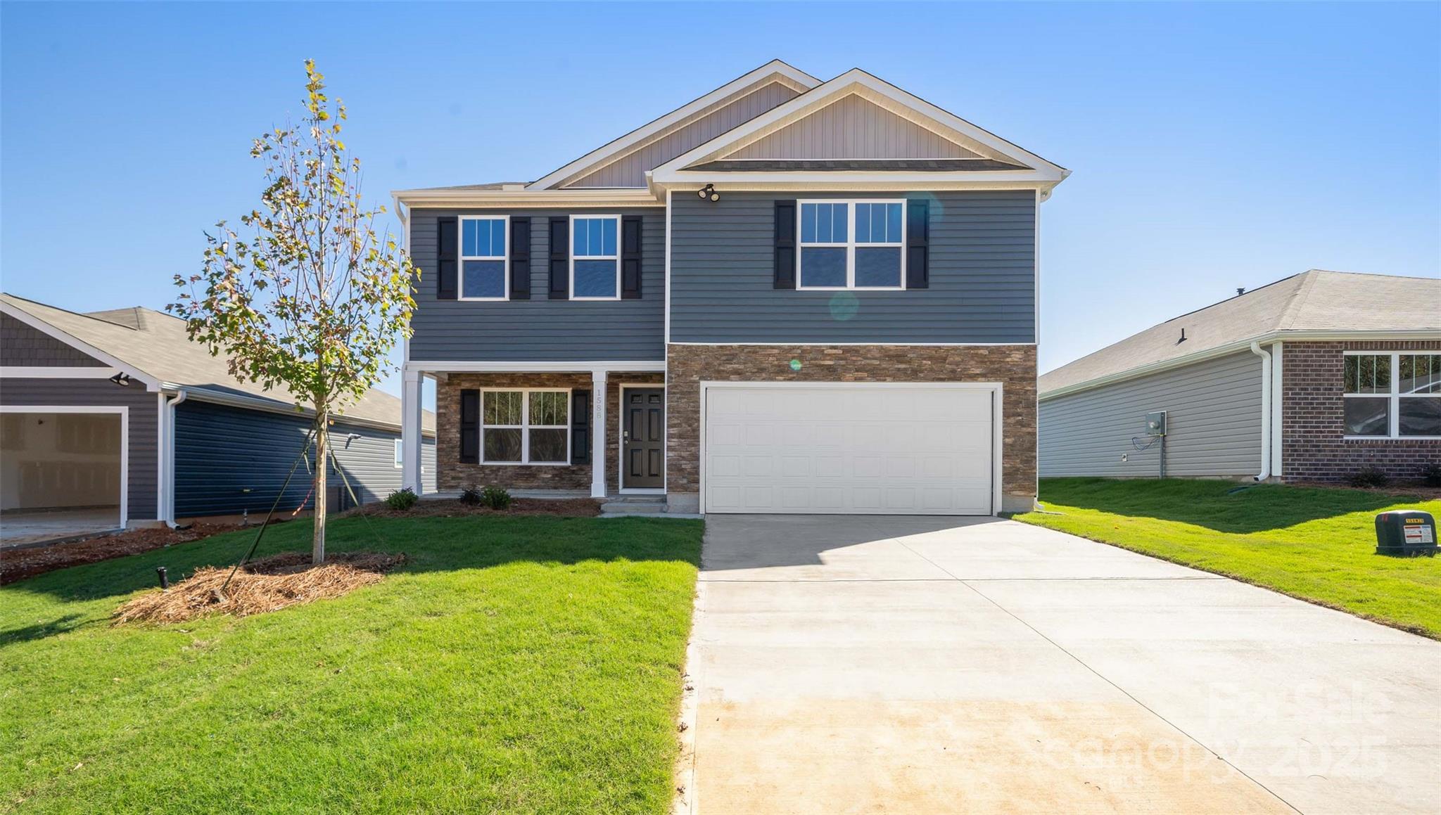 143 Callie River Clyde, NC 28721 - Photo 2 of 20 a front view of a house with a yard and garage