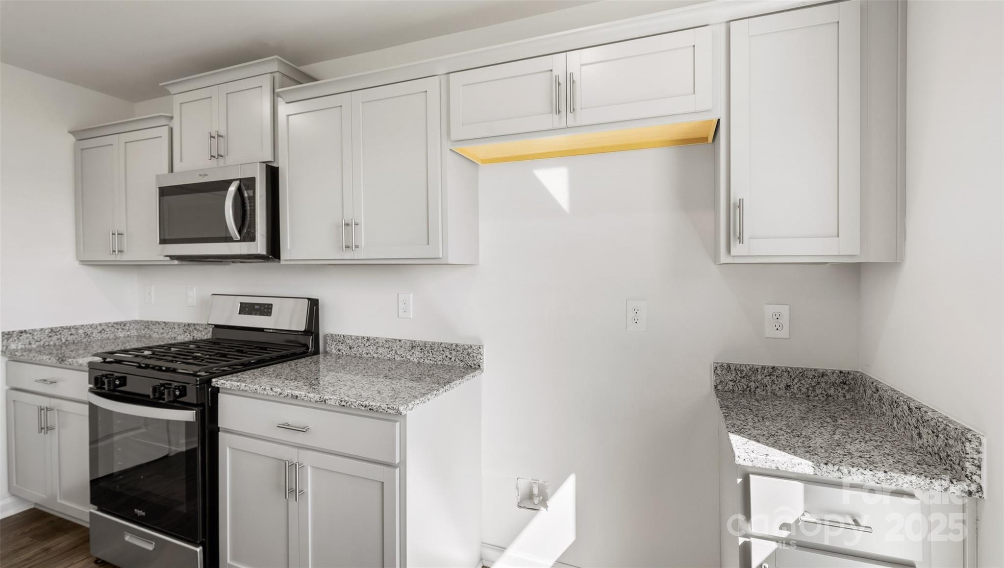 143 Callie River Clyde, NC 28721 - Photo 9 of 20 a kitchen with stainless steel appliances granite countertop white cabinets and a stove