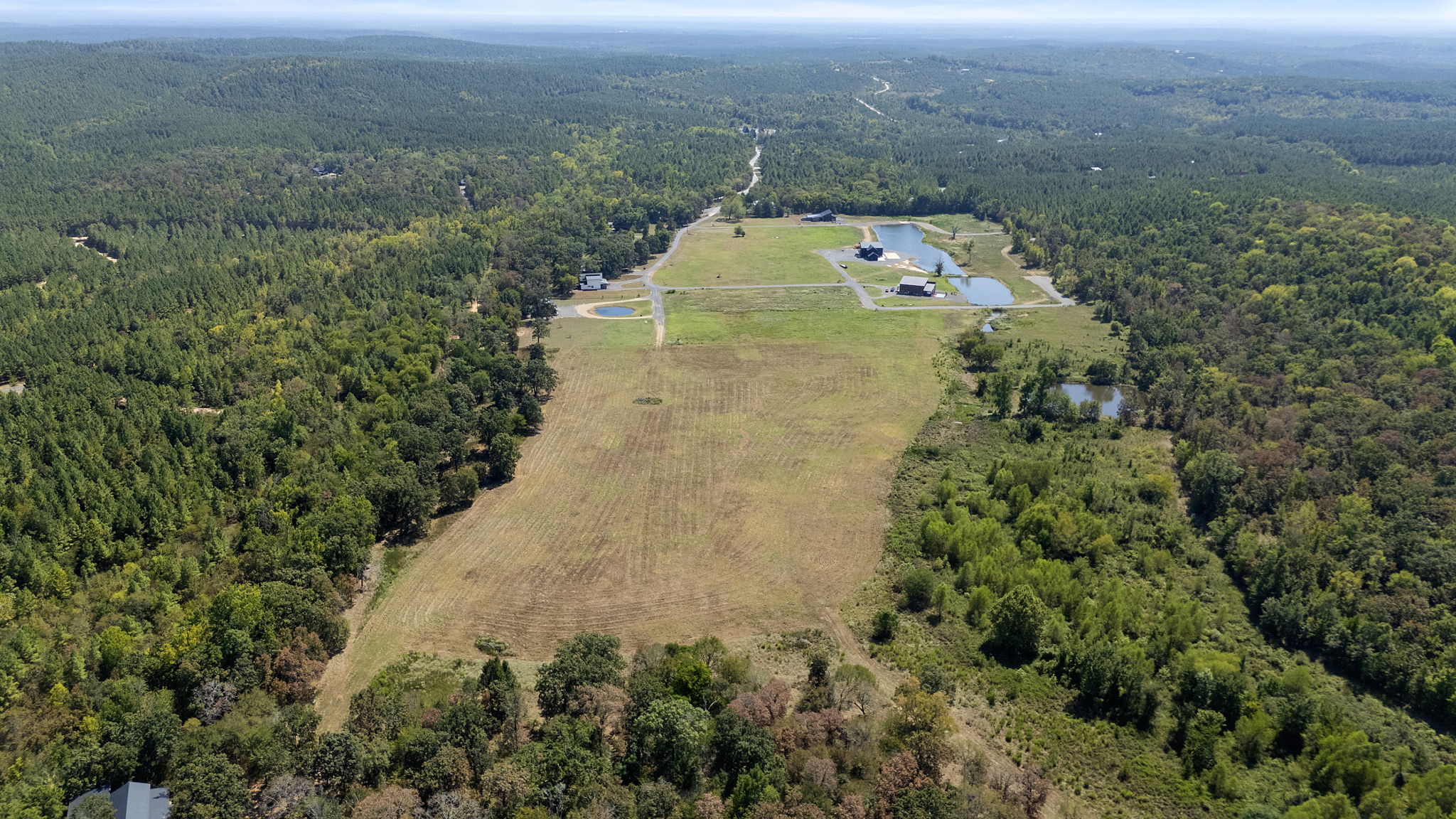 0 Rutty Pne Ridge Broken Bow, OK 74728 - Photo 7 of 22 Expansive property featuring cleared land, dense surrounding woodlands, and multiple water features