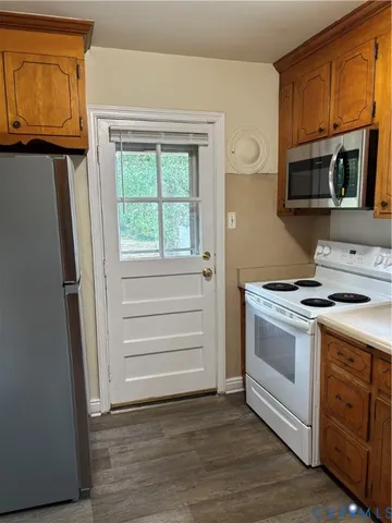 a kitchen with a stove microwave and sink