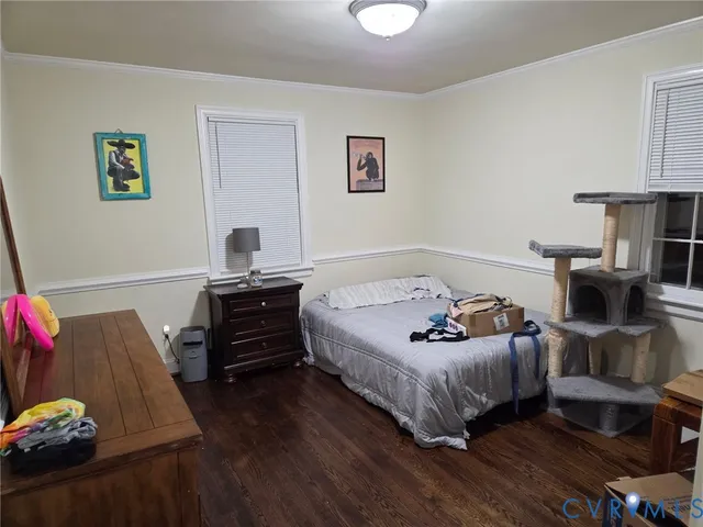 a bedroom with furniture and a wooden floor