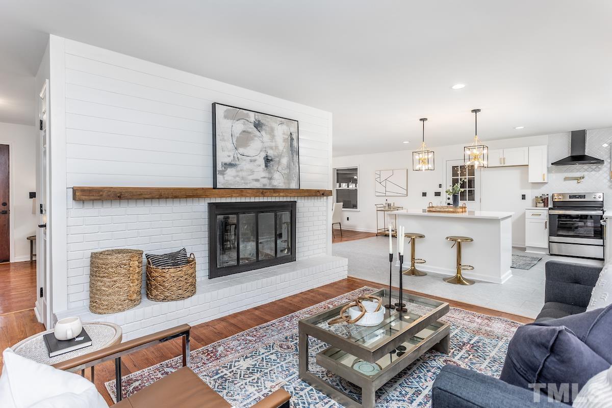 313 Lord Ashley Road Raleigh, NC 27610 - Photo 13 of 32 a living room with furniture and a fireplace