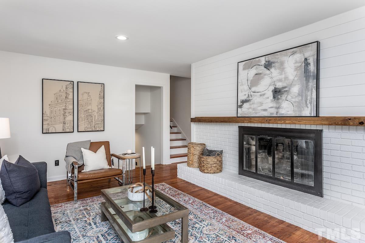 313 Lord Ashley Road Raleigh, NC 27610 - Photo 14 of 32 a living room with furniture and a fireplace