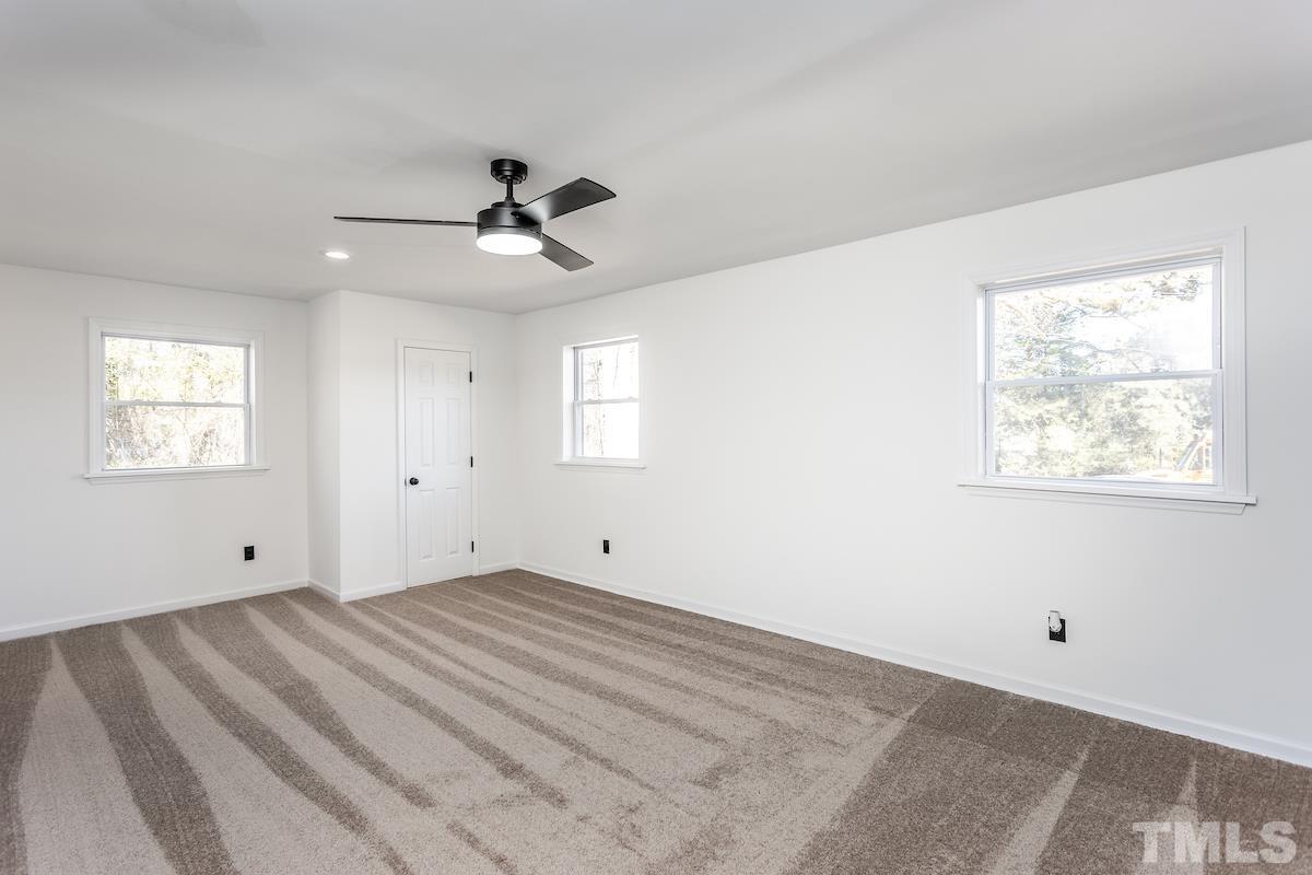 313 Lord Ashley Road Raleigh, NC 27610 - Photo 22 of 32 a view of room with window and ceiling fan