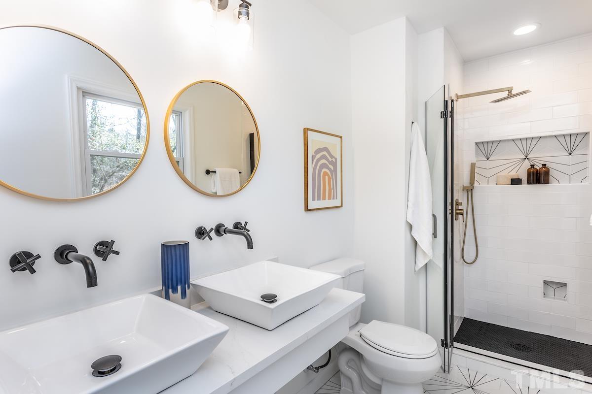313 Lord Ashley Road Raleigh, NC 27610 - Photo 27 of 32 a bathroom with a toilet sink and a mirror
