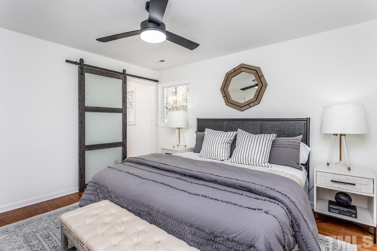 313 Lord Ashley Road Raleigh, NC 27610 - Photo 28 of 32 a bedroom with a bed and a lamp on dresser