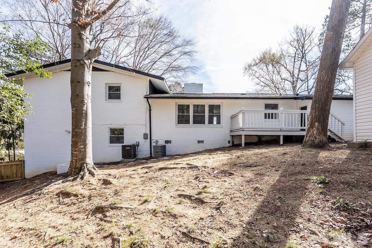313 Lord Ashley Road Raleigh, NC 27610 - Photo 30 of 32 a view of a house with backyard and trees