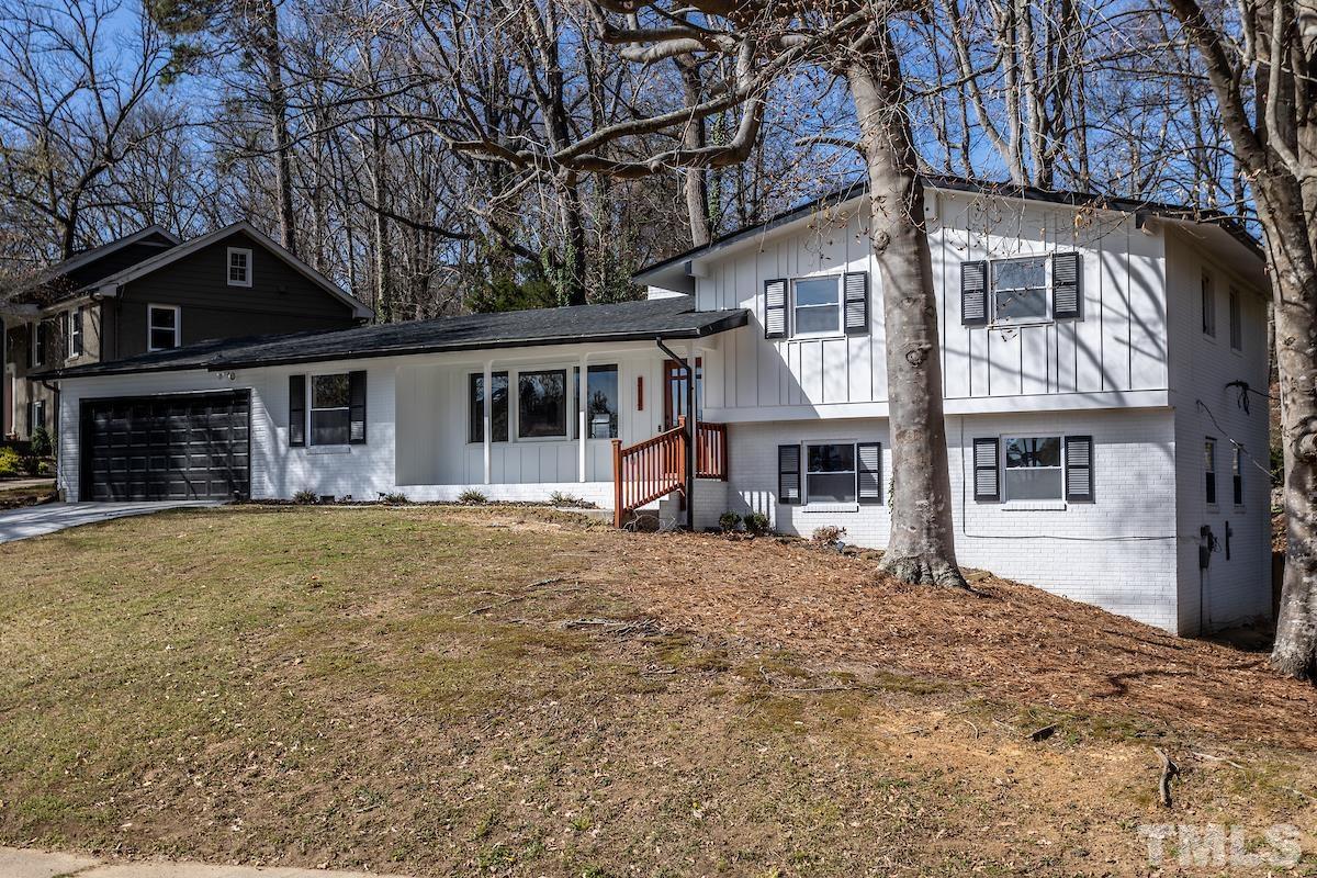 313 Lord Ashley Road Raleigh, NC 27610 - Photo 3 of 32 a front view of a house with a yard covered in snow