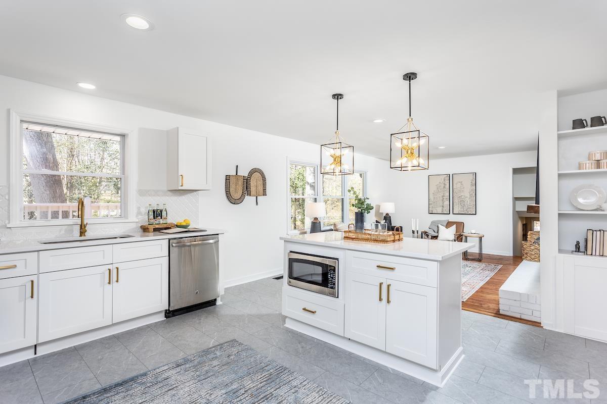 313 Lord Ashley Road Raleigh, NC 27610 - Photo 5 of 32 a kitchen with stainless steel appliances granite countertop a sink stove and refrigerator