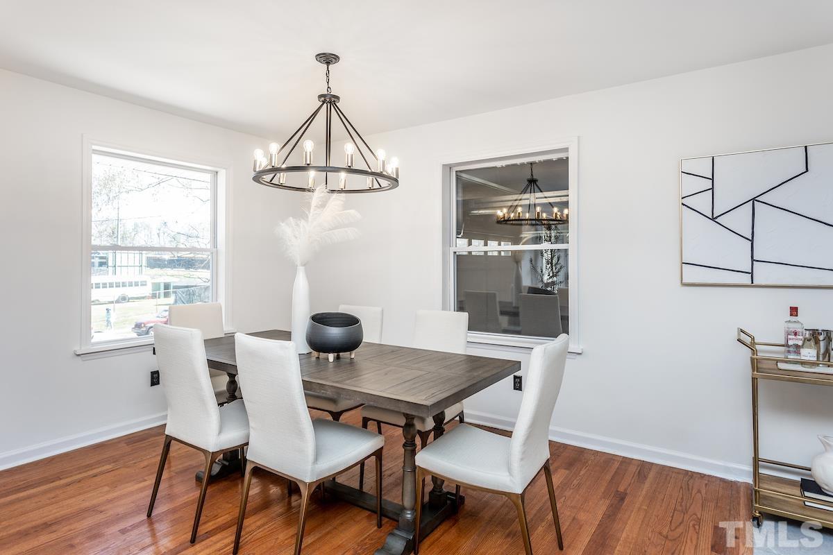 313 Lord Ashley Road Raleigh, NC 27610 - Photo 10 of 32 a view of a dining room with furniture window and wooden floor