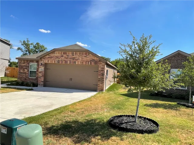 a front view of a house with a yard