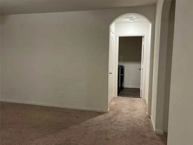 a view of a kitchen with a sink and a refrigerator