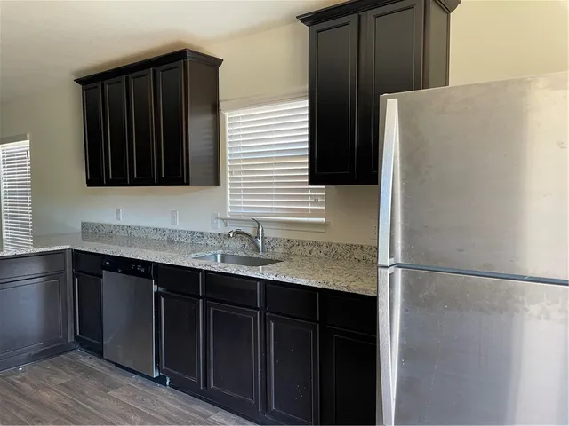 a kitchen with a sink and a refrigerator