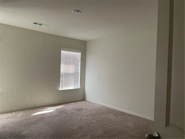 an empty room with closet area