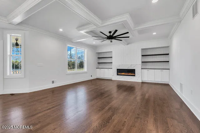 a large kitchen with stainless steel appliances kitchen island a large counter top and a refrigerator