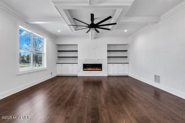 a kitchen with stainless steel appliances granite countertop a stove a sink a refrigerator and white cabinets with wooden floor