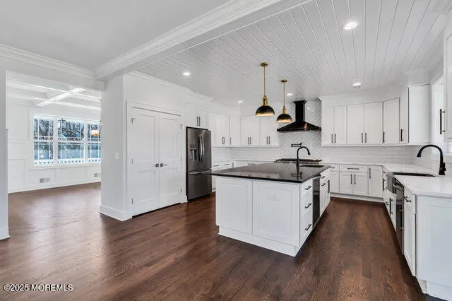 a view of a hallway with wooden floor and stairs