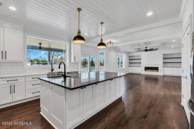a bathroom with a sink a toilet a mirror and shower