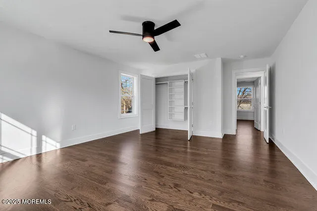 a view of a house with a big yard and large trees