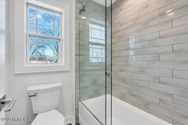 an aerial view of a house with a yard and lake view