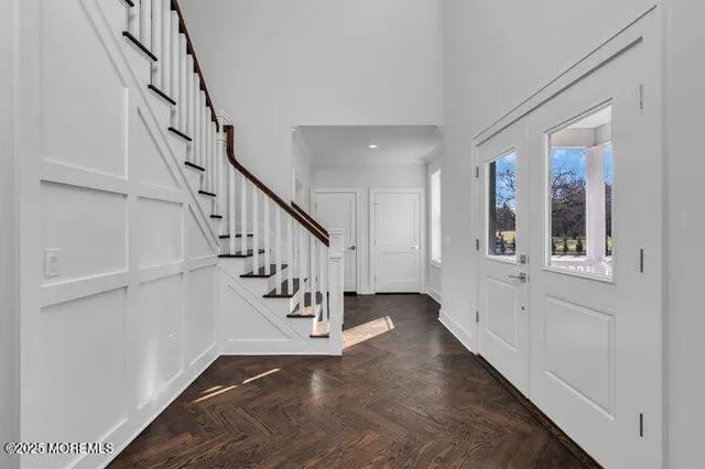 a view of entryway and hall with wooden floor