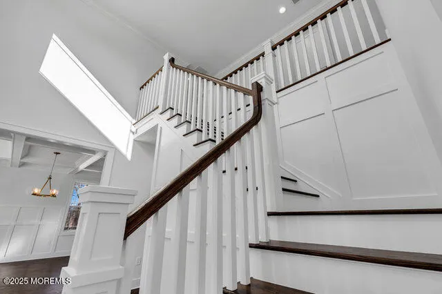 a view of a livingroom with wooden floor and a chandelier