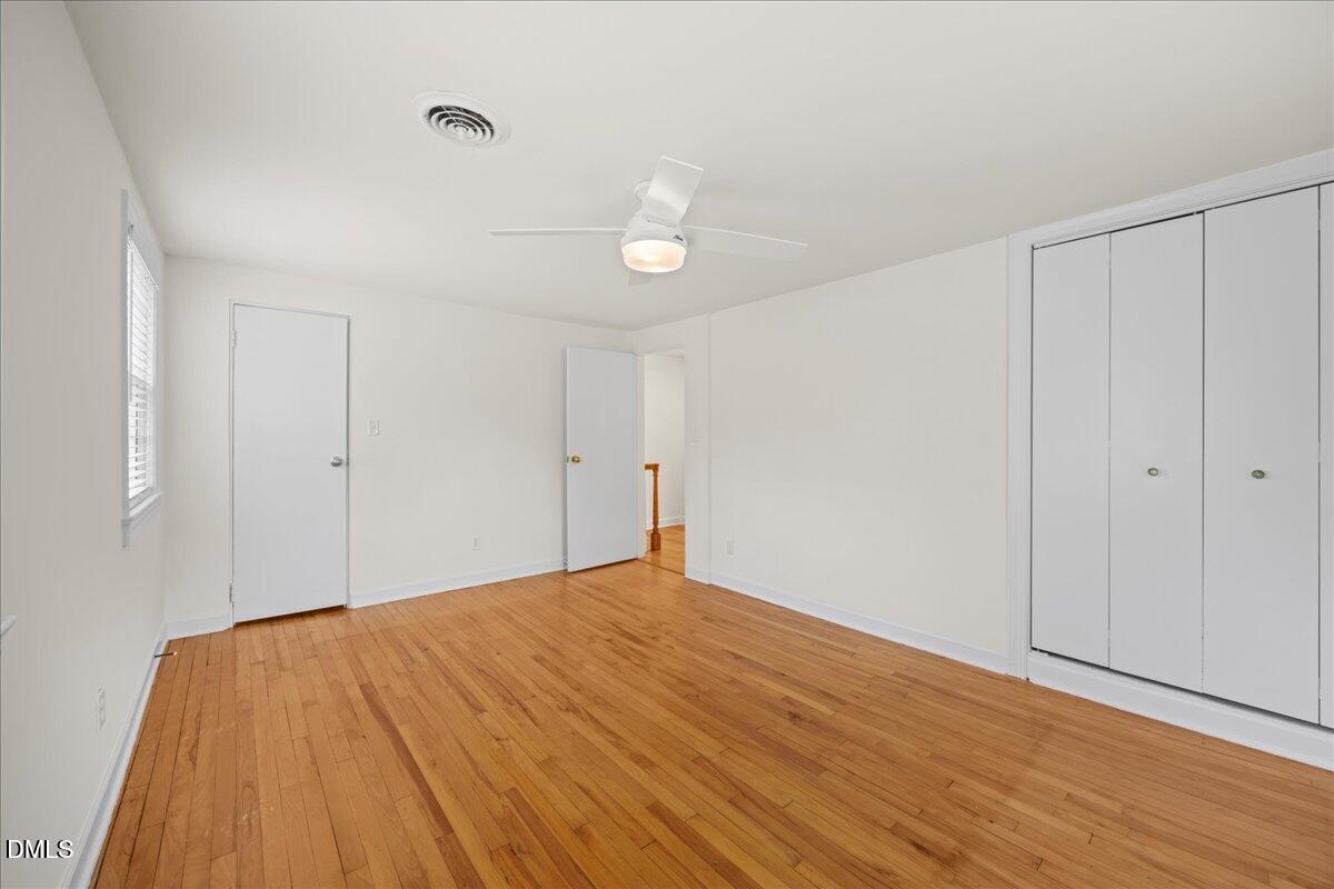 1627 Sutton Drive Raleigh, NC 27605 - Photo 18 of 33 a view of empty room with wooden floor and fan