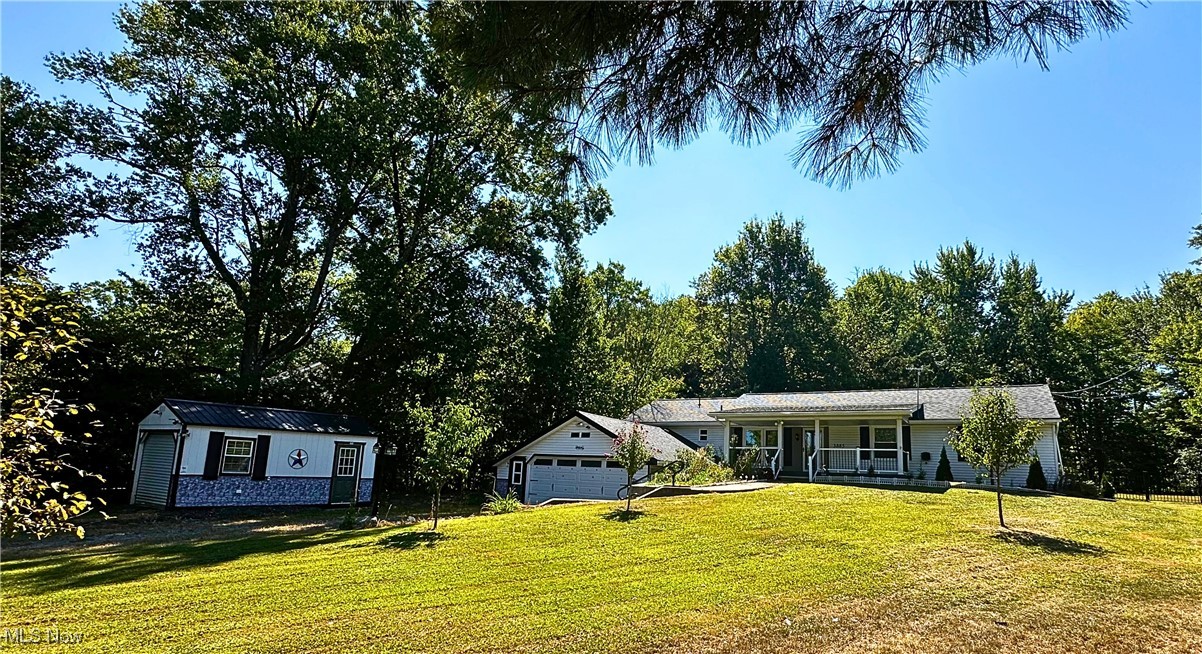3885 Shields Road Canfield, OH 44406 - Photo 1 of 38 View of front of property featuring a front lawn, covered porch, and a garage