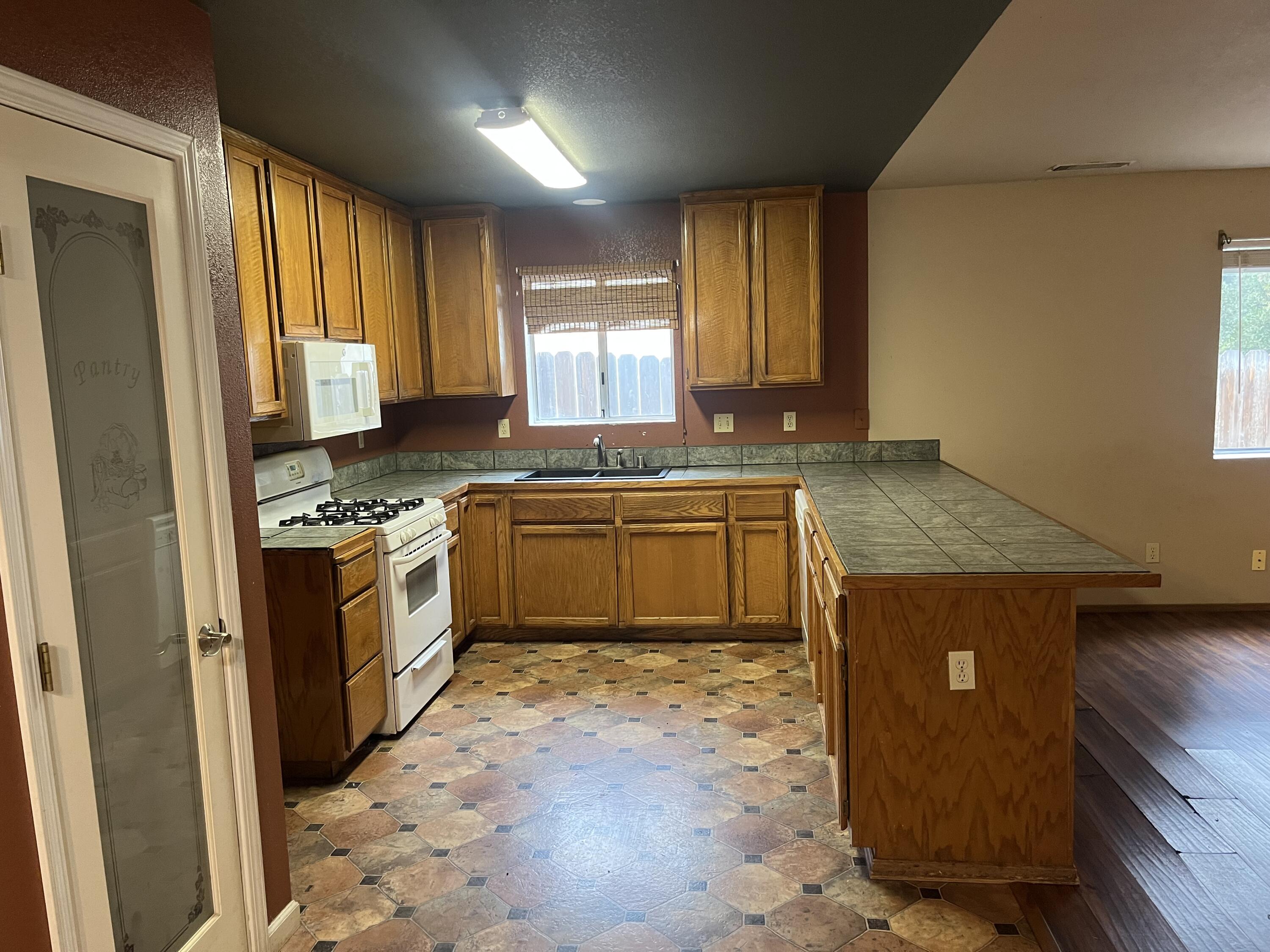 6871 Hemlock Street Redding, CA 96001 - Photo 1 of 6 a kitchen with a stove a sink and a refrigerator