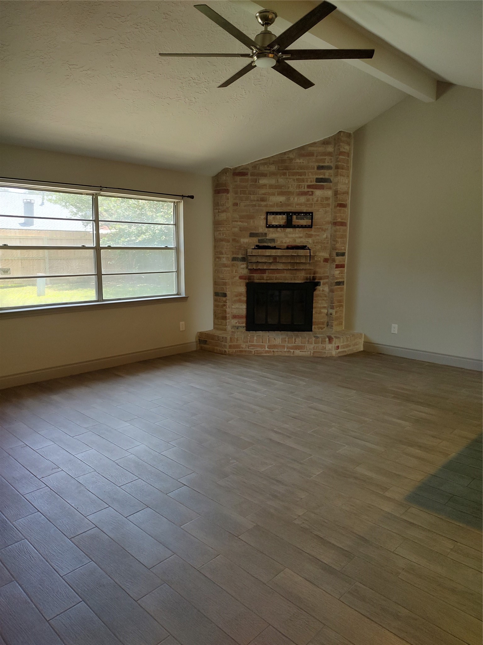 7514 Fuchsia Lane Humble, TX 77346 - Photo 5 of 20 Family room with a brick wood burning fireplace.