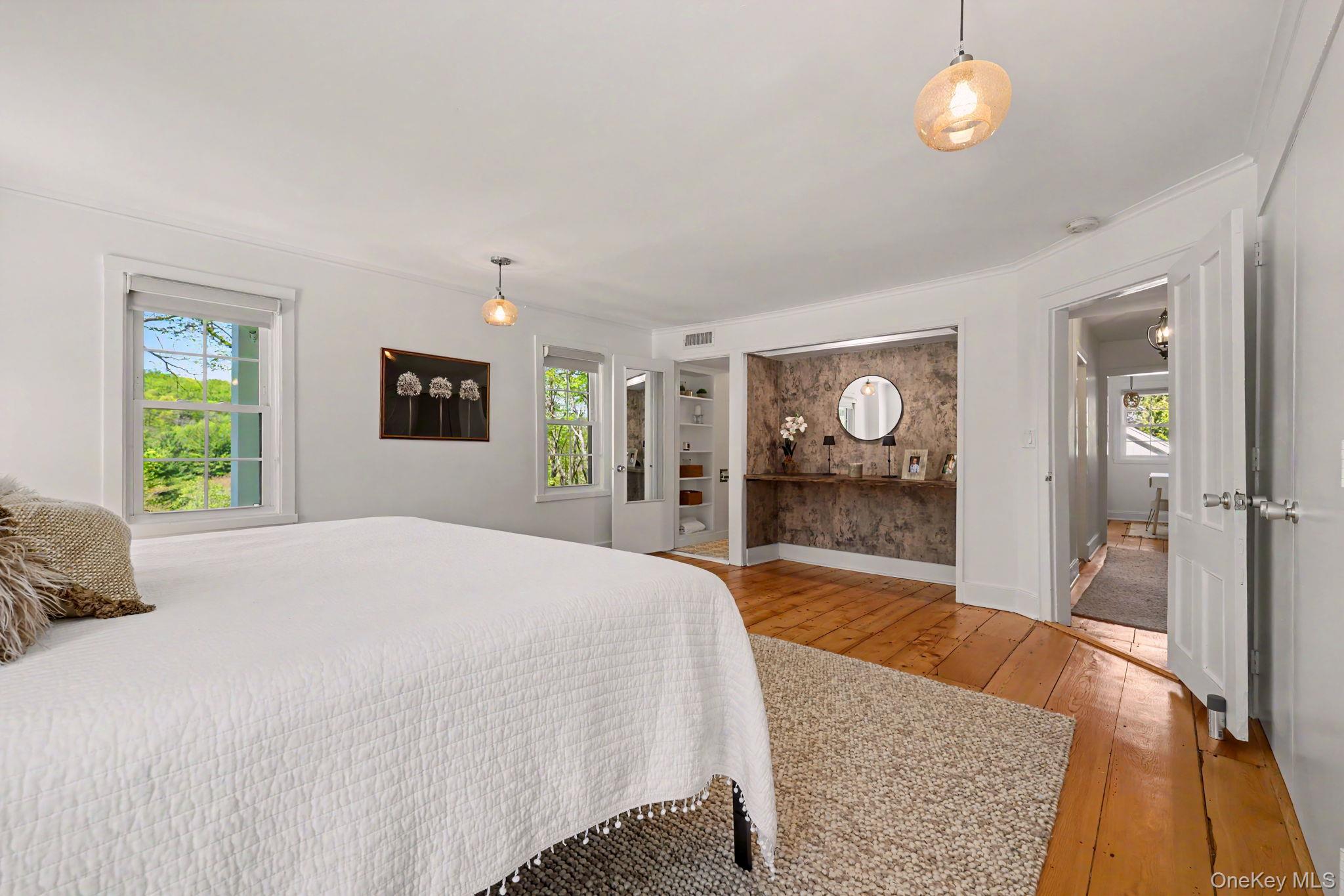 233 Long Ridge Road Bedford, NY 10506 - Photo 14 of 50 a spacious bedroom with a bed and dresser with mirror