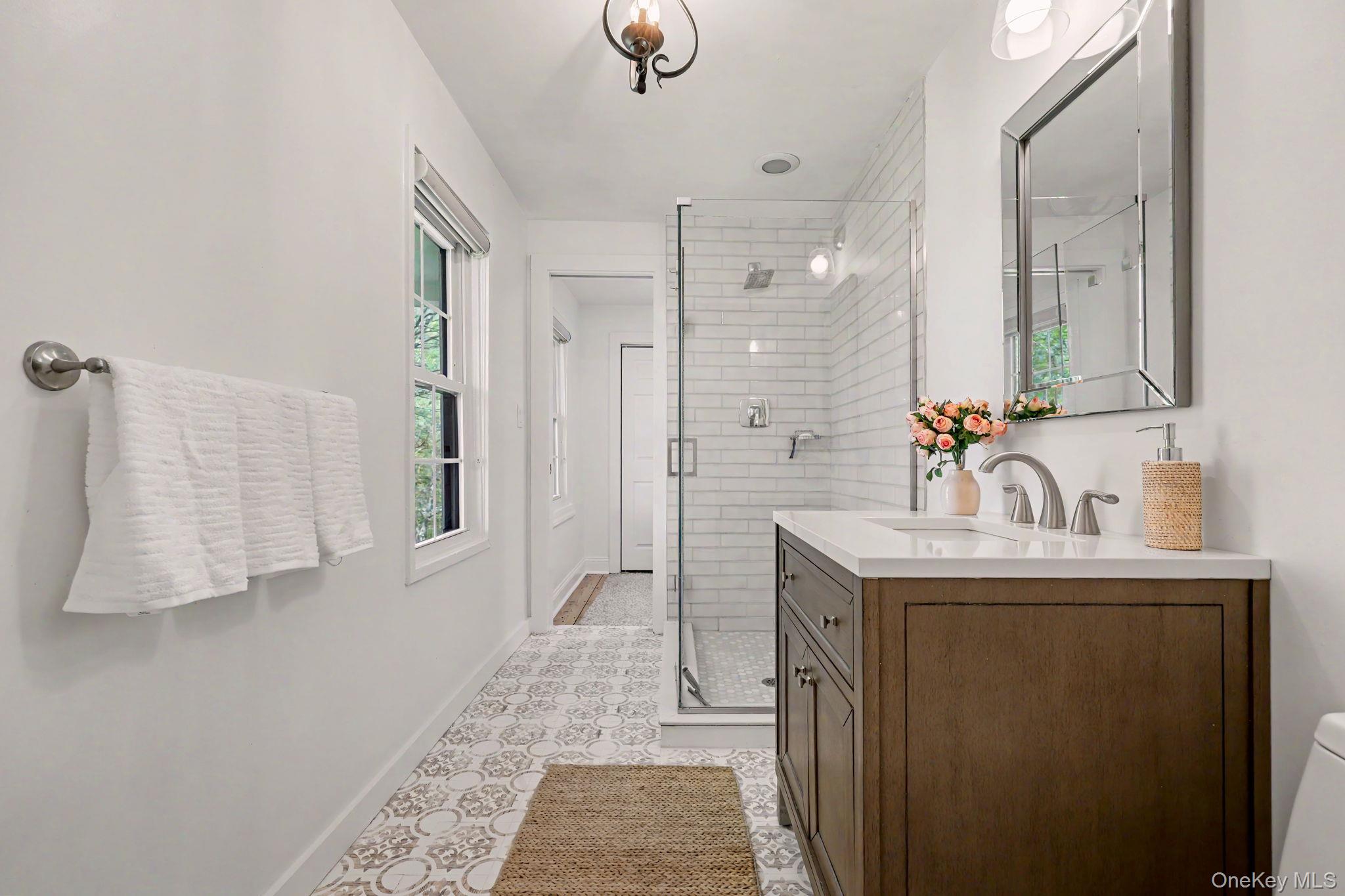 233 Long Ridge Road Bedford, NY 10506 - Photo 15 of 50 a bathroom with a sink vanity granite tub shower and a mirror