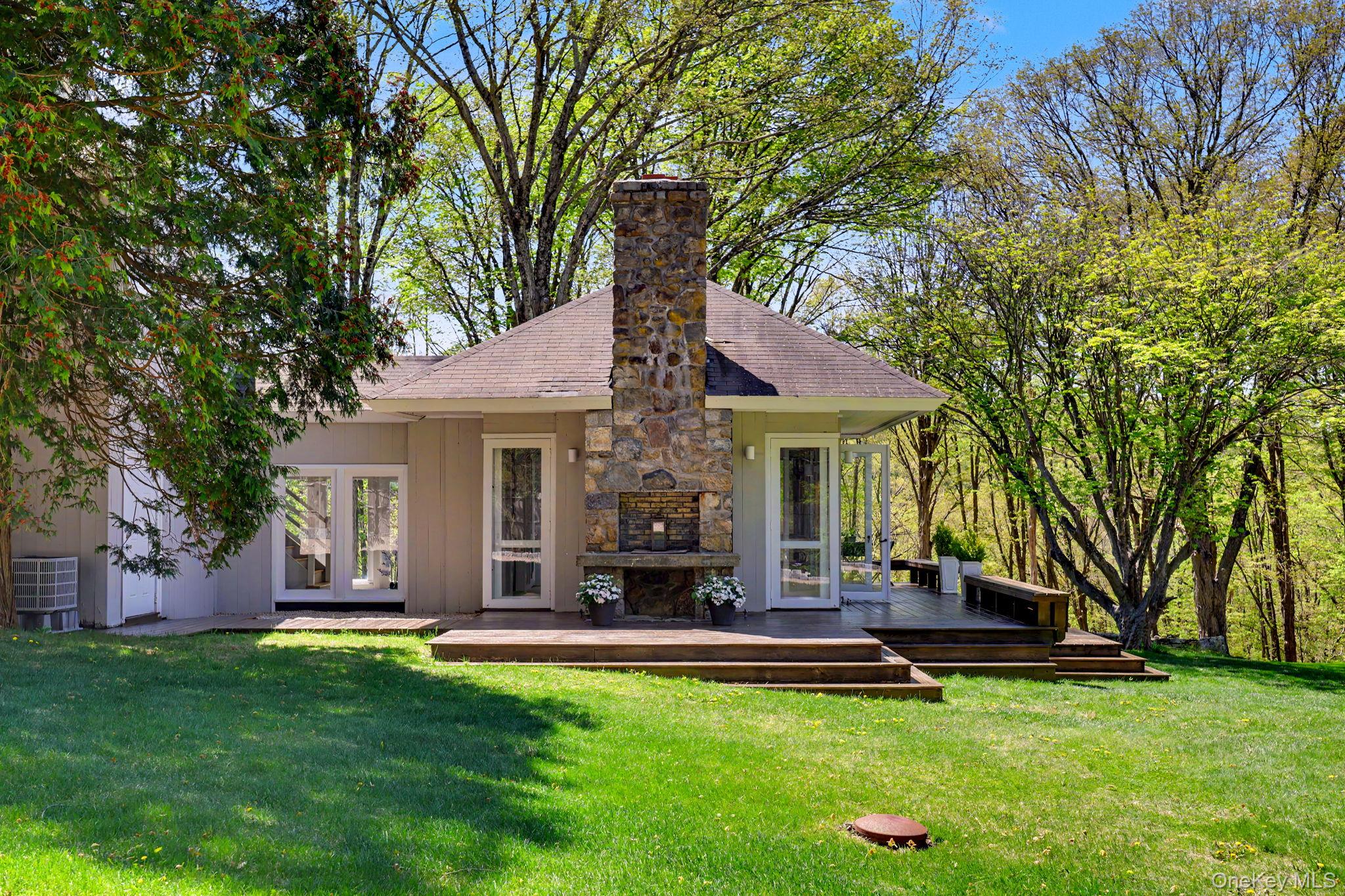 233 Long Ridge Road Bedford, NY 10506 - Photo 26 of 50 a view of a house with a backyard porch and sitting area
