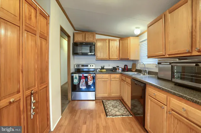 a kitchen with stainless steel appliances granite countertop a refrigerator sink and cabinets