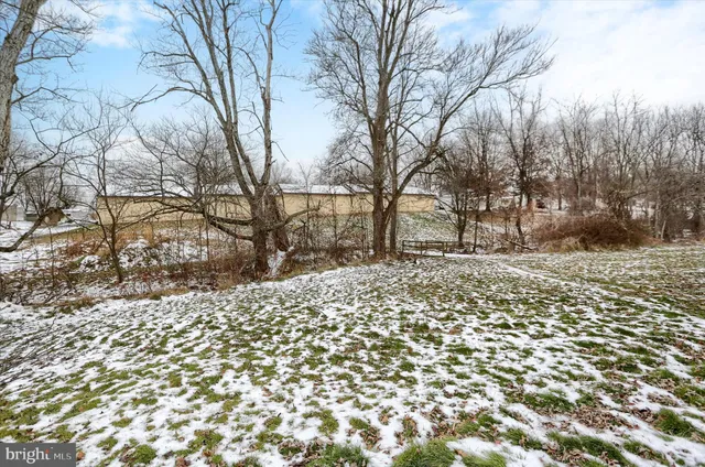 a wooden bench sitting in middle of a yard