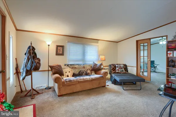 a living room with furniture and a gym cycle