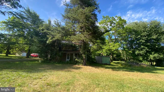 a house with green field in front of it