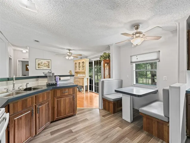 a large kitchen with kitchen island a sink stainless steel appliances and cabinets