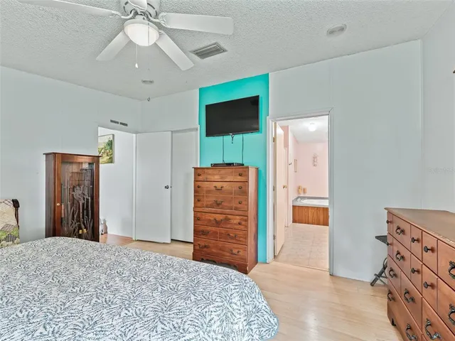 a bedroom with a bed and a dresser