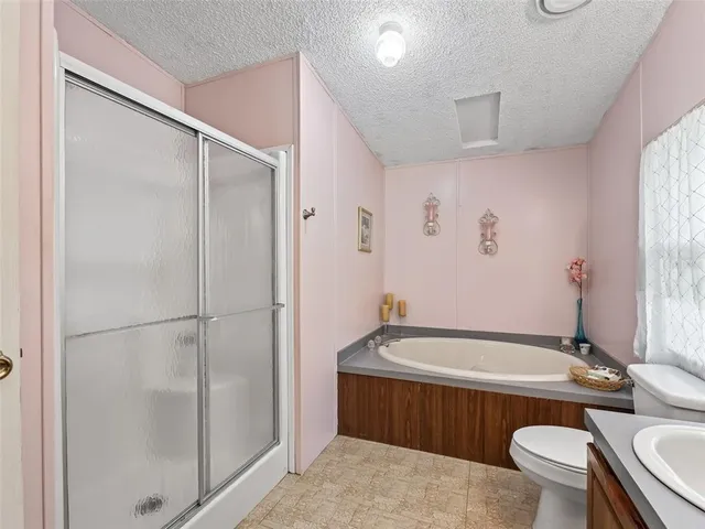 a bathroom with a tub toilet and shower