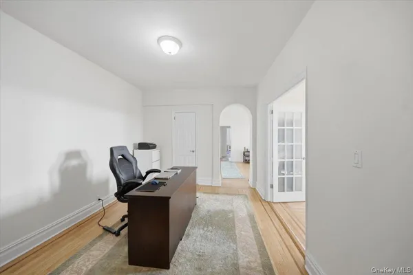 a view of a workspace with furniture and wooden floor