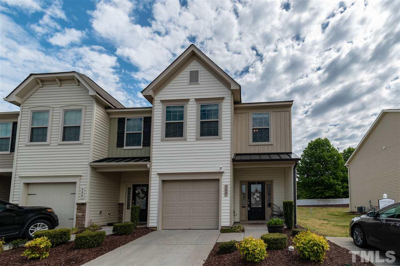 302 Leighann Ridge Lane Rolesville, NC 27571 - Photo 1 of 21 a front view of a house with garden