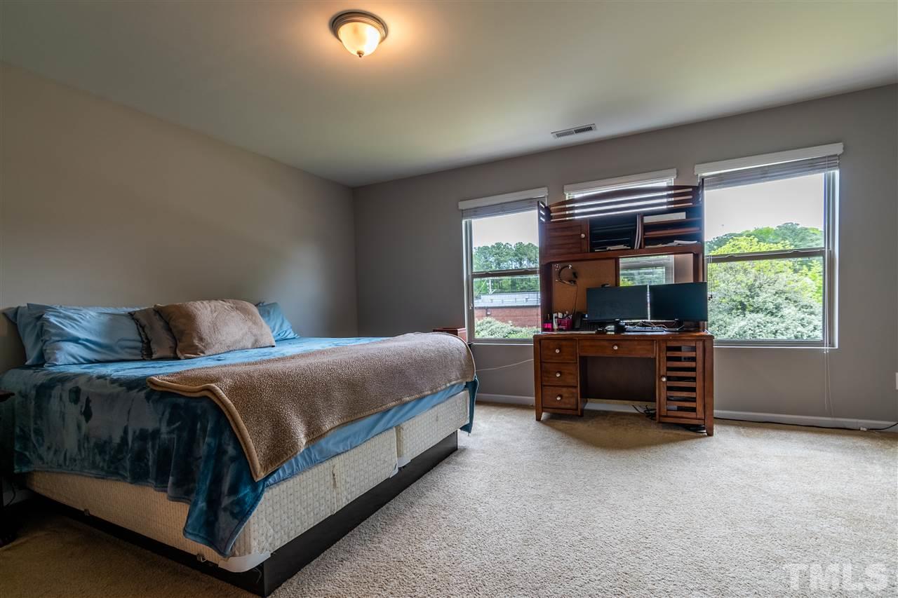 302 Leighann Ridge Lane Rolesville, NC 27571 - Photo 16 of 21 a bedroom with a bed and a television