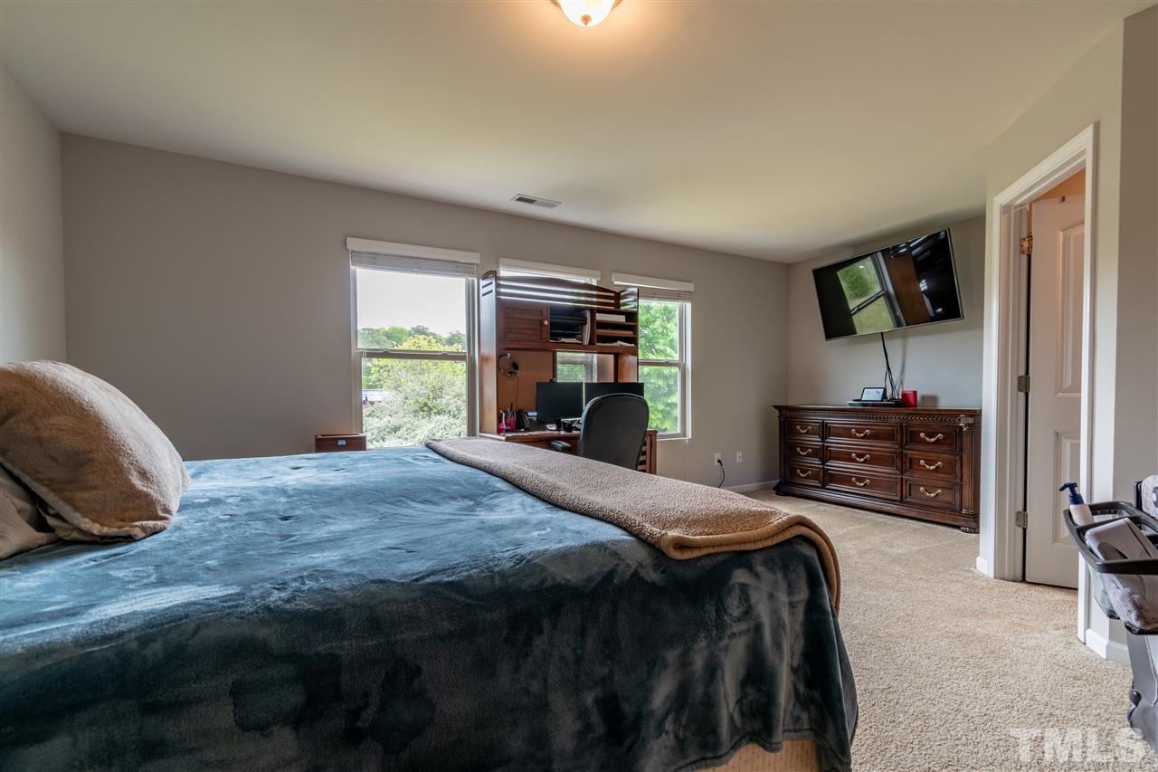 302 Leighann Ridge Lane Rolesville, NC 27571 - Photo 17 of 21 a bedroom with a bed and a television