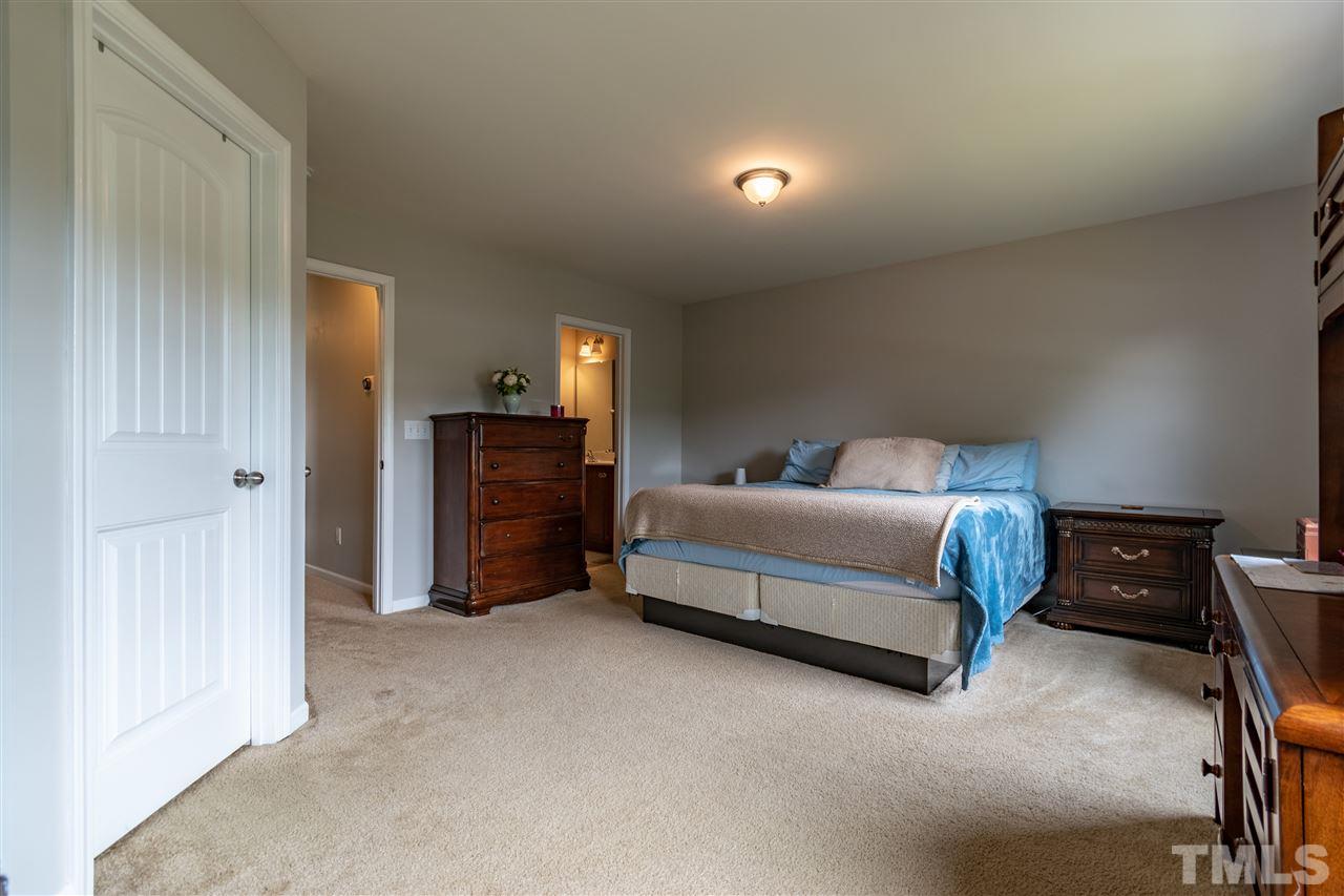 302 Leighann Ridge Lane Rolesville, NC 27571 - Photo 18 of 21 a bedroom with a bed and furniture