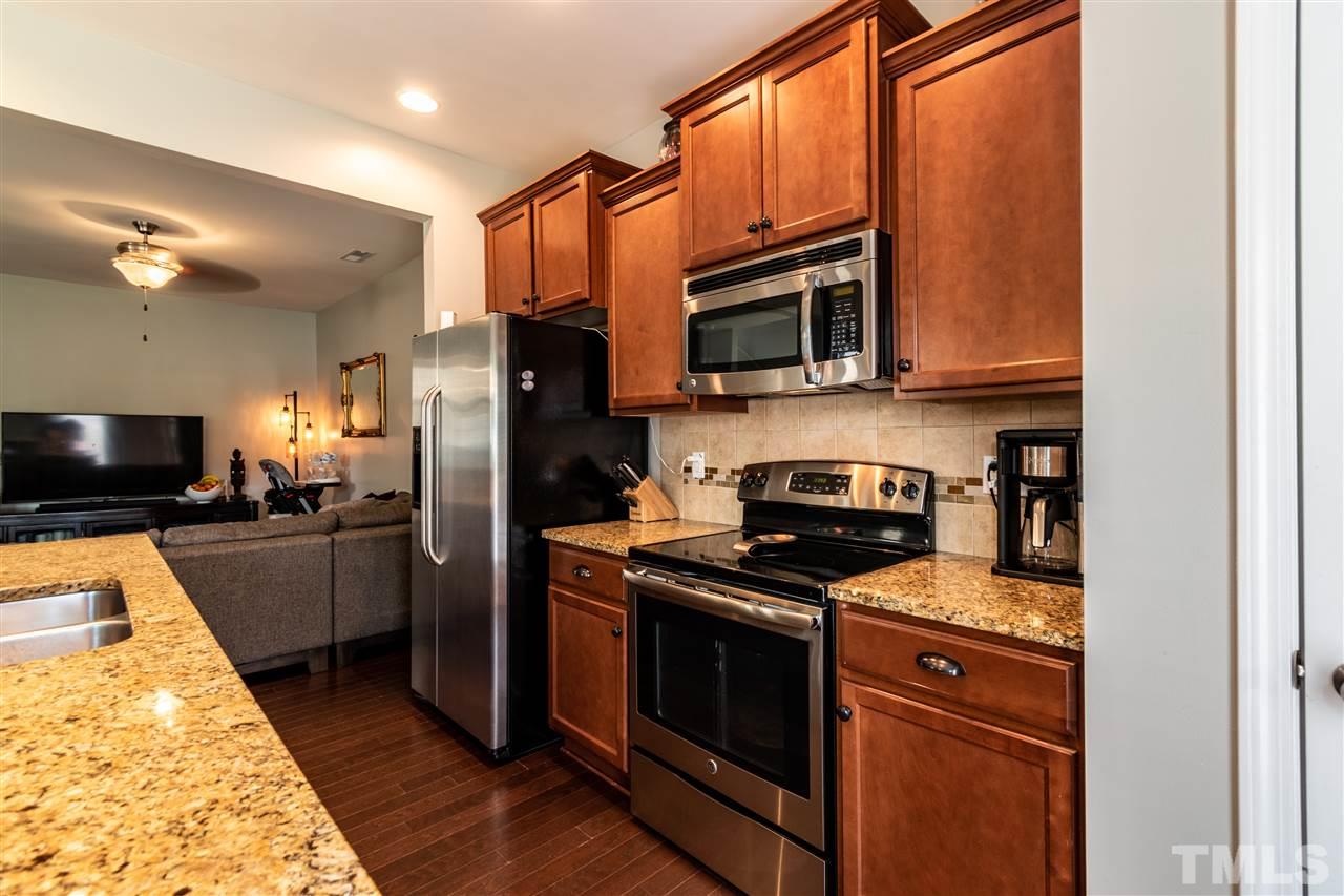 302 Leighann Ridge Lane Rolesville, NC 27571 - Photo 8 of 21 a kitchen with a refrigerator stove and microwave